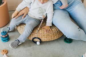 Child with pacifier Clip and toys